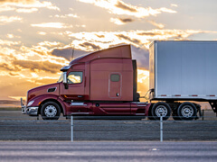 18 wheeler truck side view with sunset sky