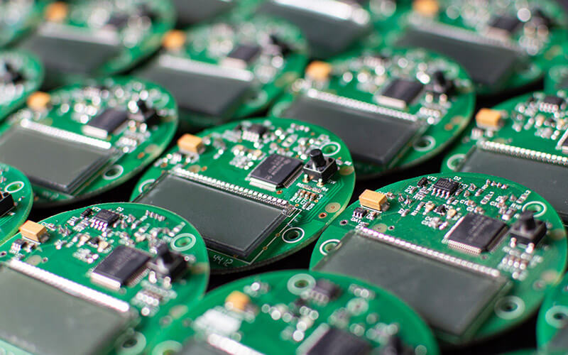 Circular green PCBs with chips and small displays arranged in rows